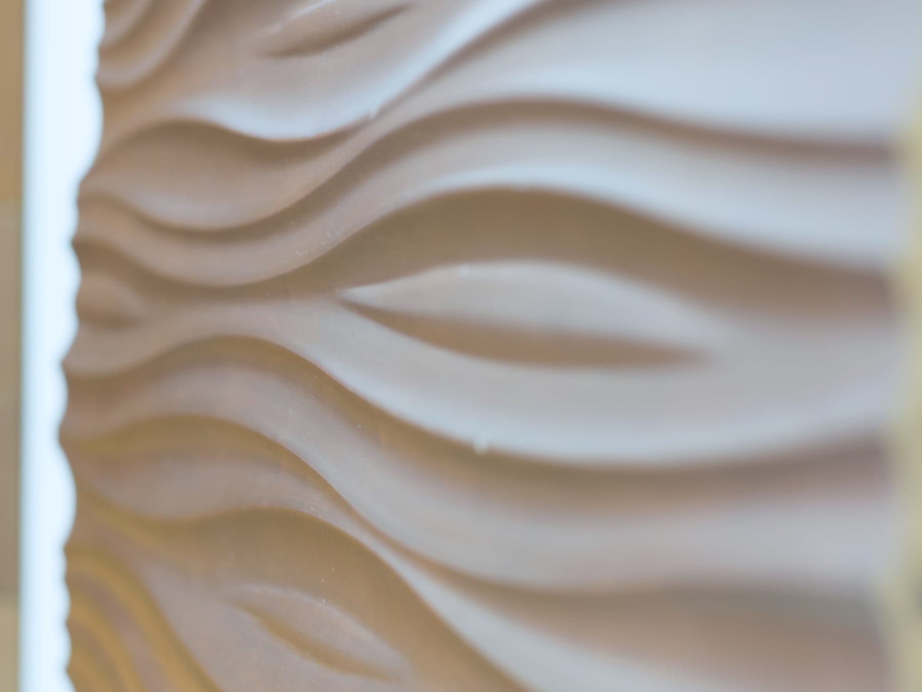 A carved panel being detailed in the workshop